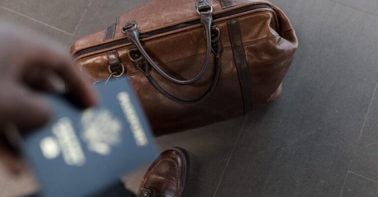 Brown leather bag with passport in an airport setting, ideal for travel and fashion themes.