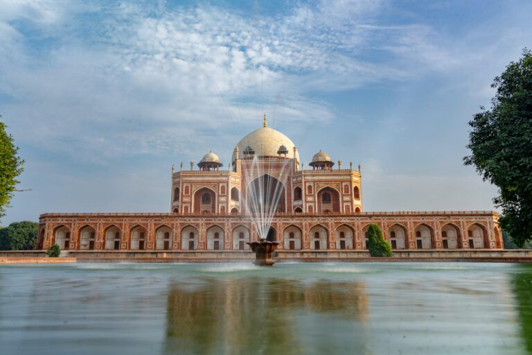 Stunning view of Humayun's Tomb with reflecting pool in New Delhi, showcasing Mughal architecture.